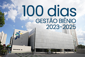 Foto colorida da fachada do novo prédio do TRT-18 com o texto 100 dias - Gestão biênio 2023-2025