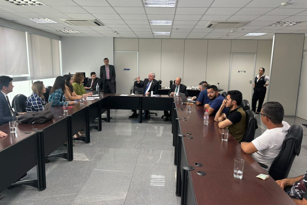 Reunião em mesa oval numa sala ampla