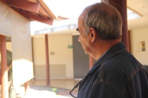 imagem mostra um idoso de costas olhando para o horizonte